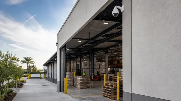 Active warehouse loading docks with pallet staging and high-bay camera coverage